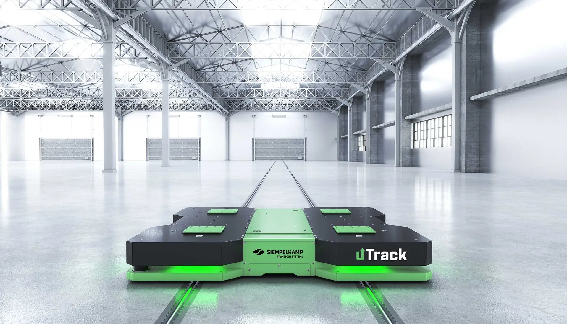 Siempelkamp uTrack Schwerlast-FTS auf bodenintegrierten Rundschienen in einer modernen Produktionshalle.